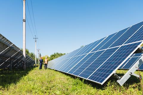 engineer-and-businesswoman-walking-near-solar-ener-2021-09-03-16-37-13-utc